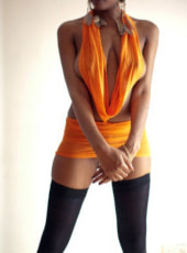 Sexy black girl in a revealing orange outfit
